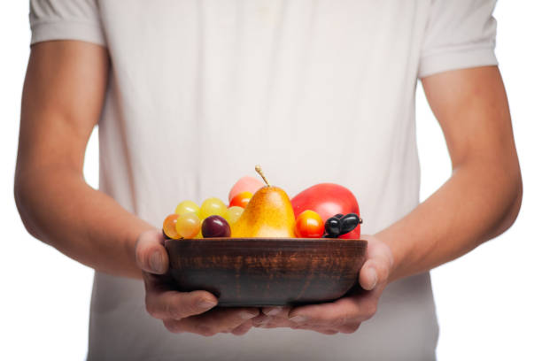 istock Men's hands hold many fruits in their hands 1230900159