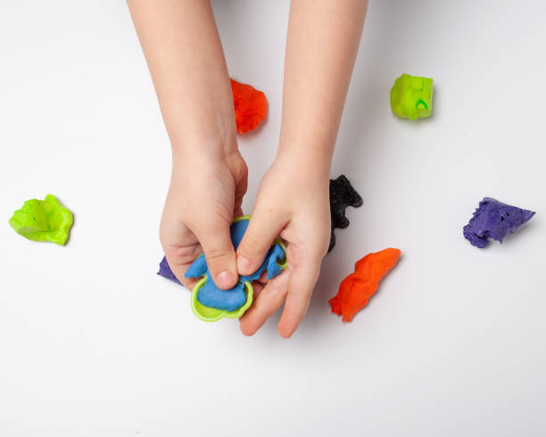 istock The hands of a little boy are making plasticine 1230901762