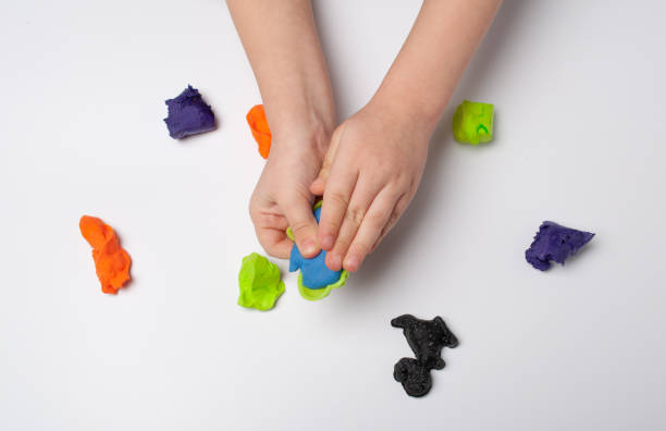istock The hands of a little boy are making plasticine 1230901770
