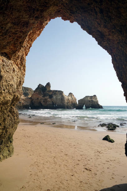 beach near alvor in the algarve beautiful rock formations and arches at beach near Alvor in the Algarve alvor stock pictures, royalty-free photos & images