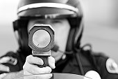 Black and white photo of cop with speed gun