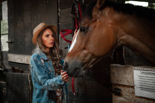 istock Young woman with a horse 1230961029
