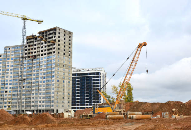 istock Crawler crane at the construction site. Digging a pit for the building of an underground tunnel of the metro line. Subway construction project background. Small sharpness 1230968314