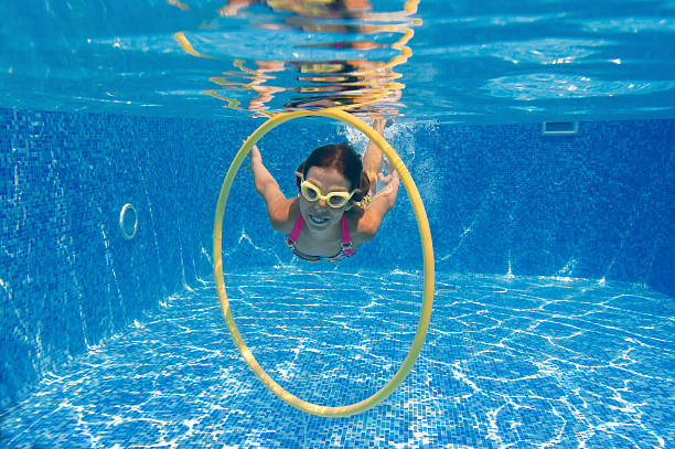istock Girl swimming underwater in pool 123099175