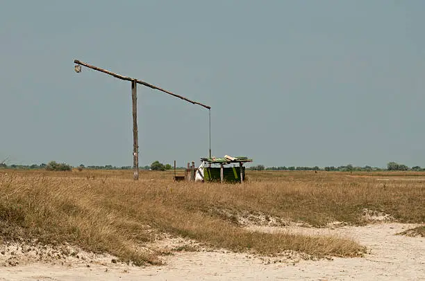 Landscape of the beautiful Hungarian great plain area with an old traditional waterpump on it.