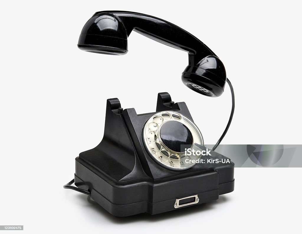 Vintage rotary telephone Old black vintage rotary style telephone isolated over a white background Answering Stock Photo