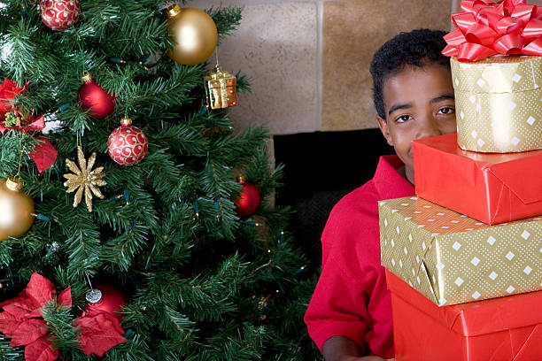istock Kid hiding behind Christmas presents 123107323