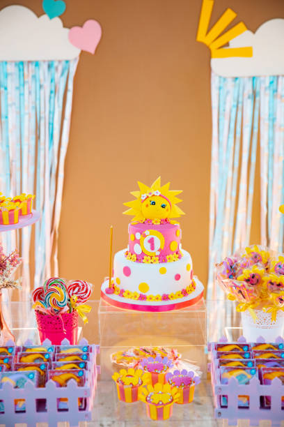 istock Birthday Setup. Cake table with sweet, decoration and flowers. 1231076559
