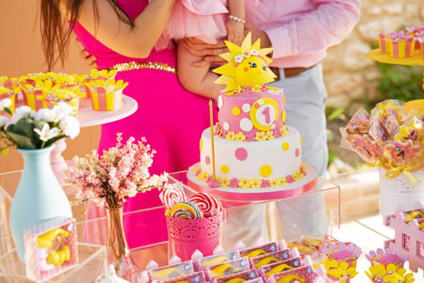 istock Birthday Setup. Cake table with sweet, decoration and flowers. 1231078086