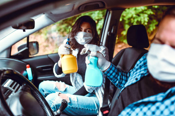 istock Couple Playing With Spray Bottles While Cleaning Car 1231087623