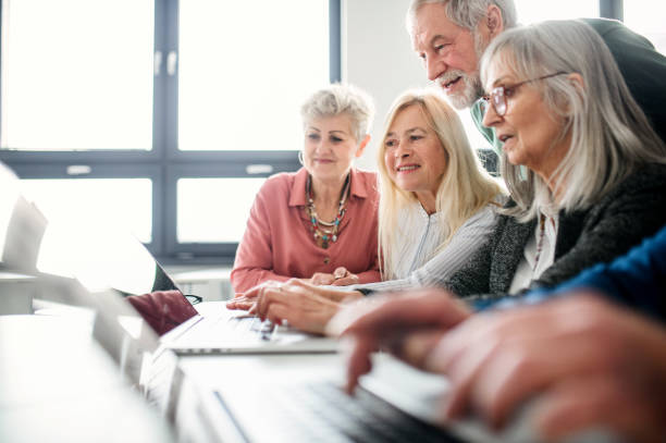 istock Group of senior people attending computer and technology education class. 1231108982