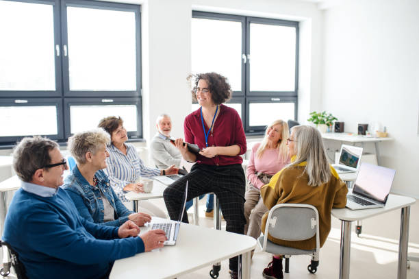 istock Group of senior people attending computer and technology education class. 1231109665