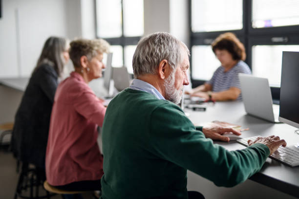 istock Group of senior people attending computer and technology education class. 1231111041