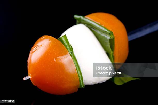 Caprese Skewer On Black Pad Stock Photo - Download Image Now - Appetizer, Basil, Buffet