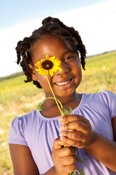 istock Little Girl Smiling With Flower 123114534