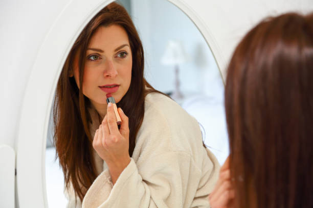 istock Beautiful woman applying red lipstick 1231224524