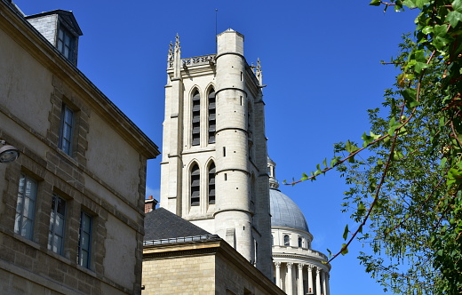 Latin Quarter, Paris, France. View of the Pantheon Dome and the Lycee Henri IV tower with blue sky from a nearby street.