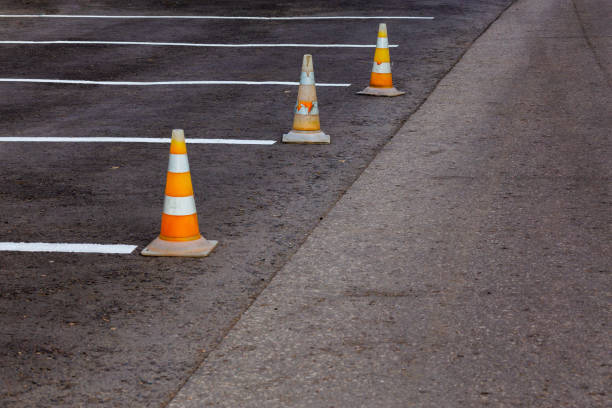 istock Orange road cones on a asphelt driving area with white lines 1231247093