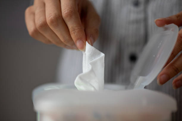 istock Wet wipes are universal an practical: woman take one wipe from big plastic box package for cleaning 1231279417