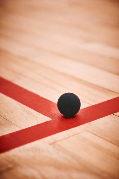Shot of a squash ball on the floor of a squash court