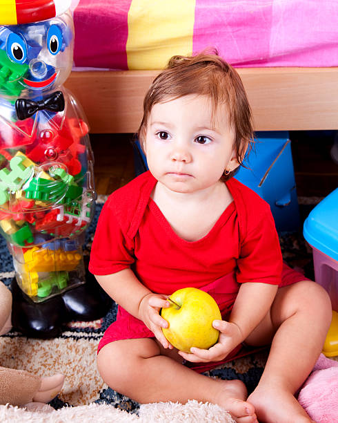 istock Cute baby holding an apple 123137373