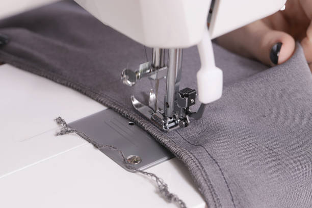 istock Close-up of hands sewing on machine 1231383500