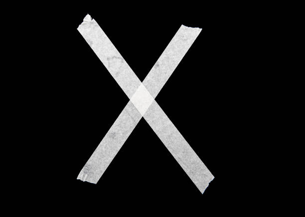 istock White cross by adhesive tape on black background 1231385044