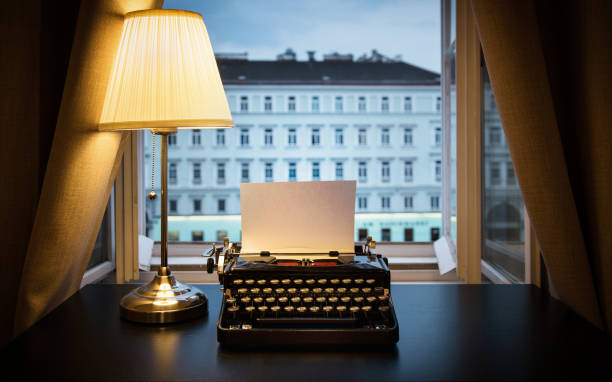 istock Workplace of a writer, journalist, creator. An old typewriter and a lamp on the table. Retro style. The concept on scientific, historical, literature, education and philosophical topics. 1231394472