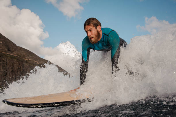 istock Male surfer rides the wave on his surfboard 1231415011