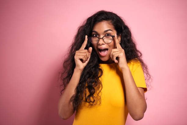 istock African woman looking behind the glasses in studio shot. 1231433500
