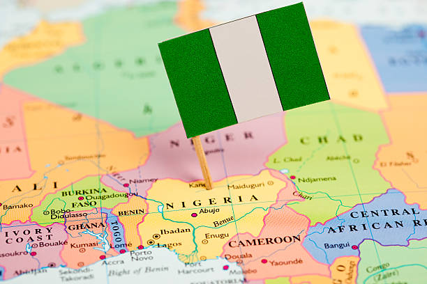 Red push pin pointing at France on plastic globe, plan for travelling concept