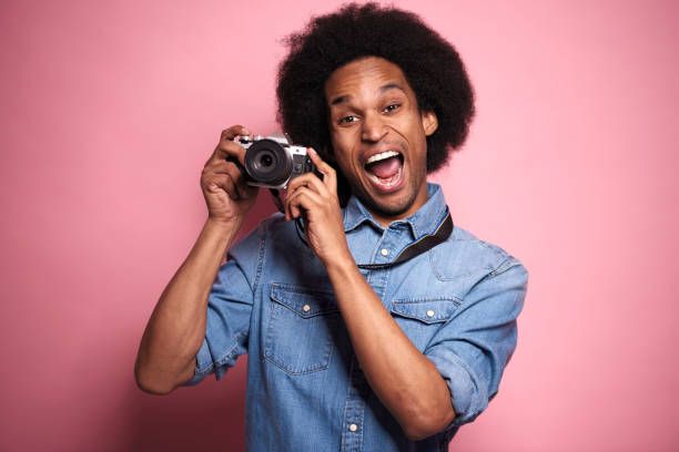 istock Happiness African man with digital camera in studio shot. 1231460790