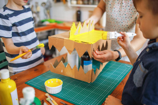 istock Brothers painting a cardboard dinosaur costume 1231481825