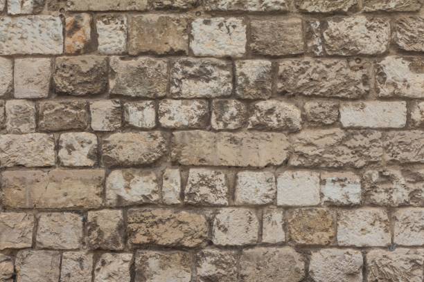 istock Old stable stone wall with rows of crafted masonry stones 1231483458