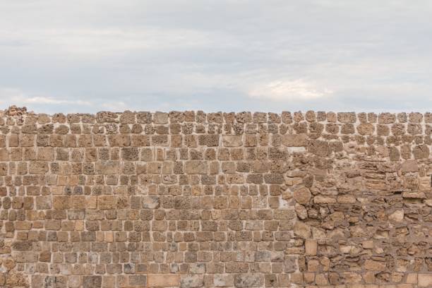 istock Old stable stone wall with rows of crafted masonry stones 1231484476