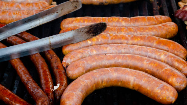 istock Grilled sausages and barbecue tongs. 1231486537