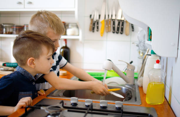 istock Boys Washing brushes in the sink 1231492234