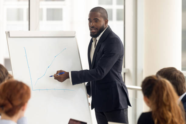 istock African american businessman presenting new project at presentation. 1231520900