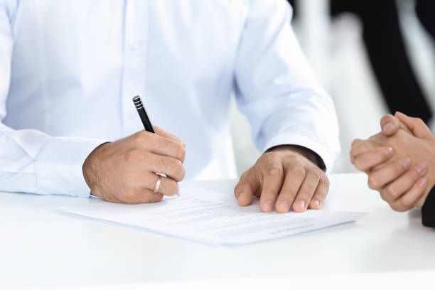istock Close up man hand signing at meeting concept. 1231521426