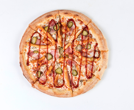 Pizza with pickles, sprinkled with tomato ketchup. Pizza on a white background