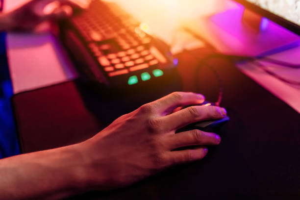 istock Close-up of a gamer's hand on a computer mouse playing video games online 1231562045