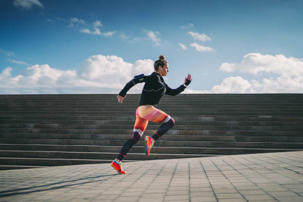 Sportswoman sprinting in the city Young woman running in Barcelona athlete stock pictures, royalty-free photos & images