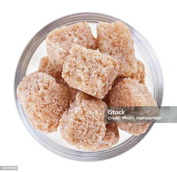 Brown Lump Cane Sugar In A Glass Bowl Isolated Stock Photo - Download Image Now - Beige, Bowl, Brown