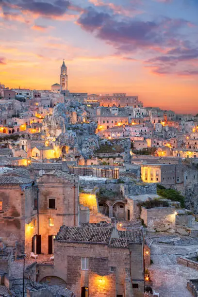 Cityscape aerial image of medieval city of Matera, Italy during beautiful sunset.