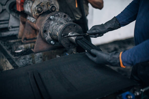 istock Two men working on coal for hookah production line in factory 1231638738