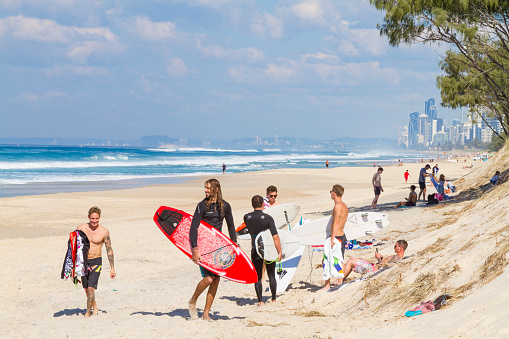 July 27, 2019 - The Spit - Main Beach, Gold Coast, Queensland, Australia: Group of Australians males athletes surfing at Main Beach in winter time in Australia.