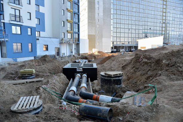 istock Laying heating pipes in a trench at construction site. Install underground storm systems of water main and sanitary sewer. Cold and hot water, heating and heating system of apartments in the house 1231681728