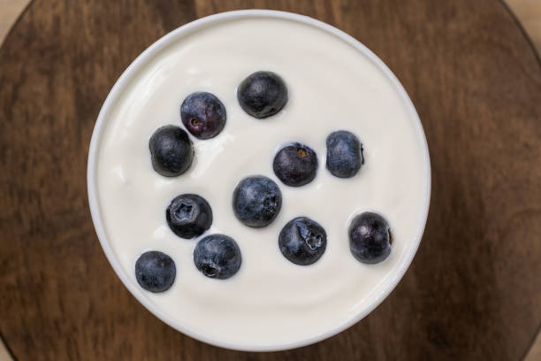 istock Yogurt with resh blueberries, in bowl over old wood background. 1231694029