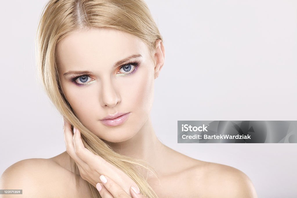 Young pretty woman with beautiful blond hairs Young pretty woman with beautiful blond hairs and multicolor makeup isolated on white background 20-24 Years Stock Photo