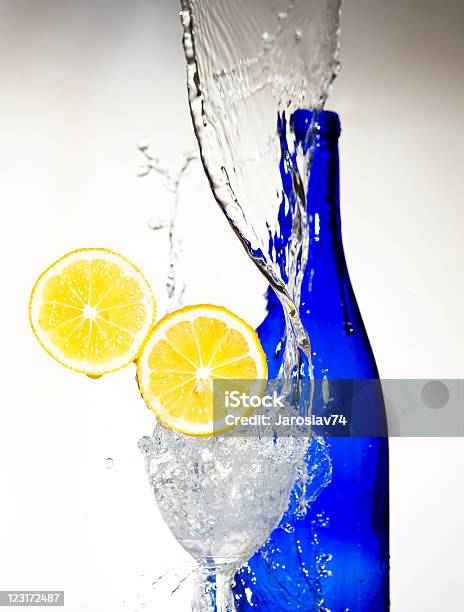 Lemon With Spray Water Creativ Splashing Stock Photo - Download Image Now - Antioxidant, Blue, Bottle